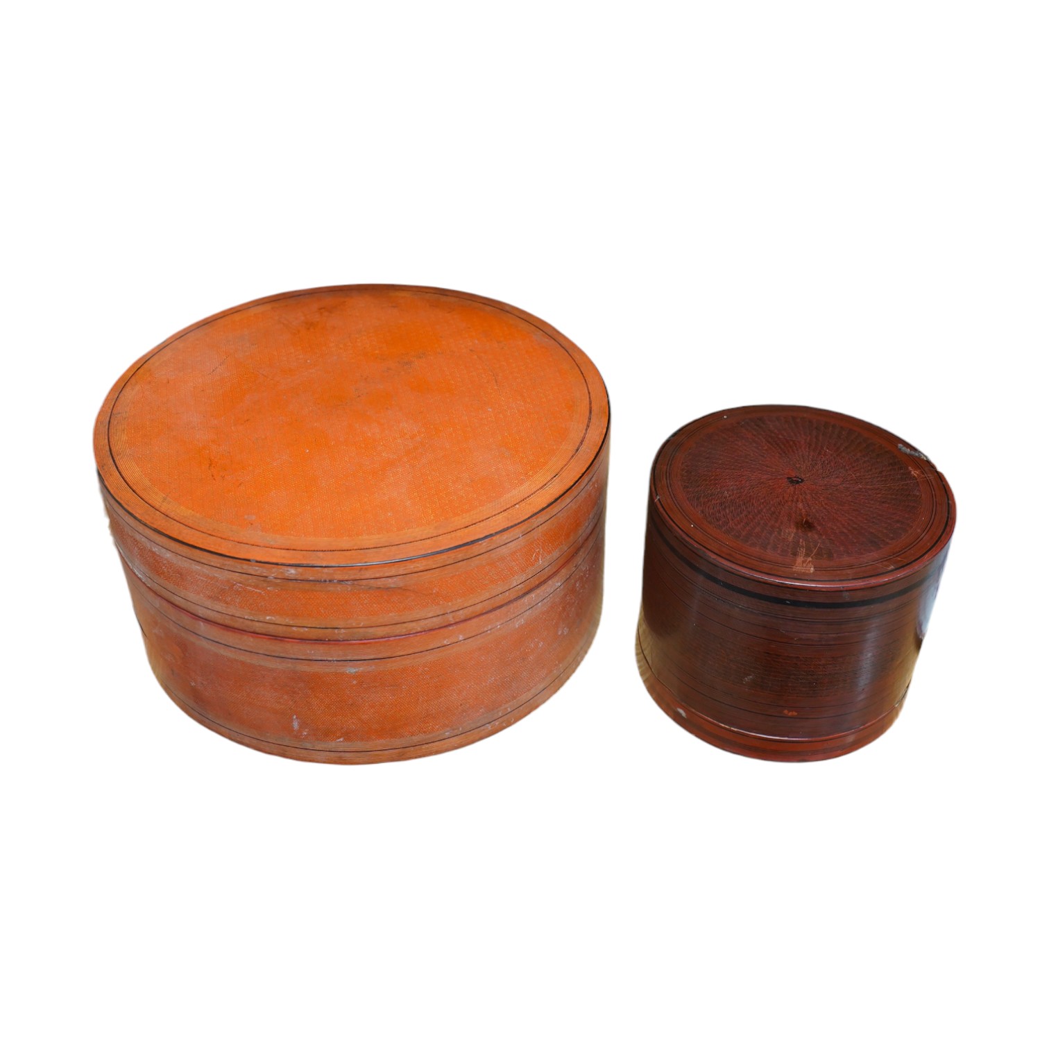 Two 19th century Burmese lacquered cylindrical boxes, largest 27cm in diameter. Condition - poor